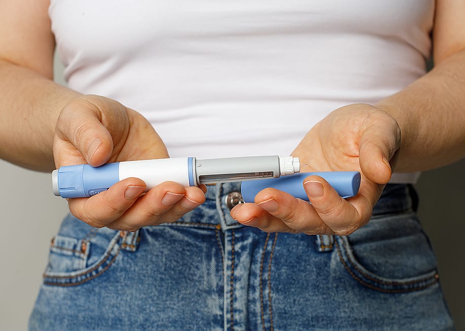 Person holding a Semaglutide pen. — MillaF // Shutterstock