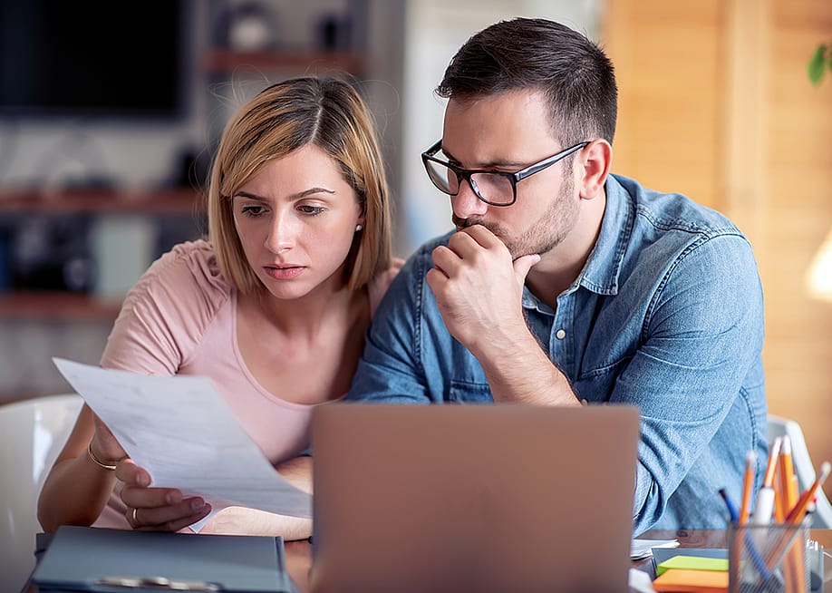 A couple analyzing finance documents. — Ivanko80 // Shutterstock