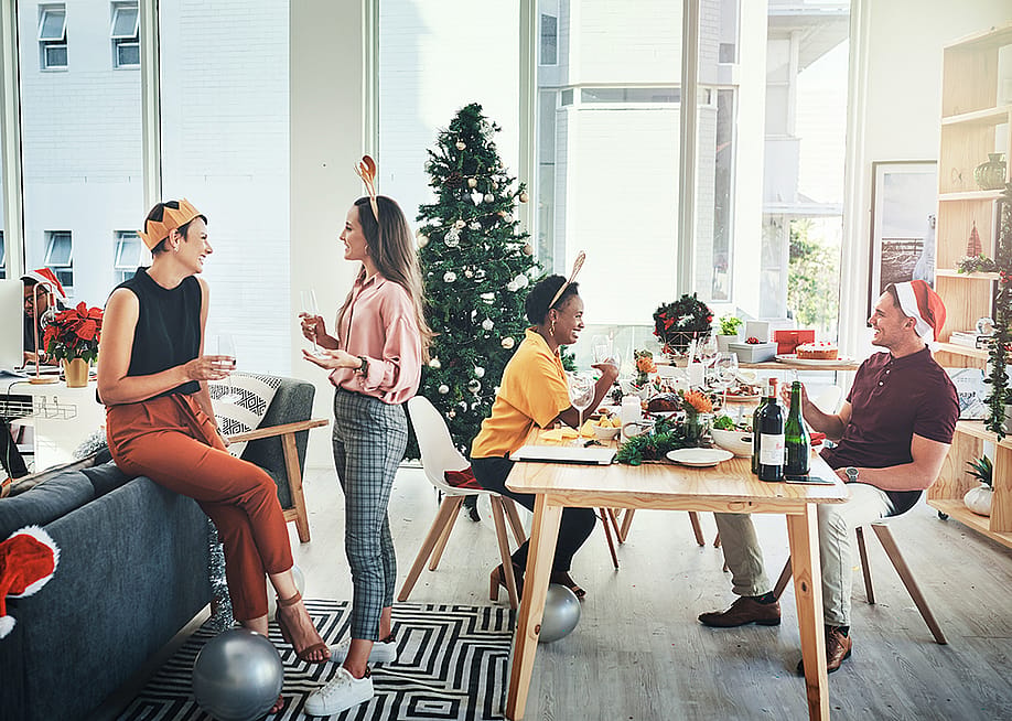 Coworkers having a Christmas party in their office. — PeopleImages // Shutterstock