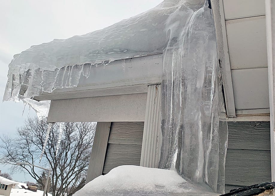 Thick ice dam formed on a house's roof. — HomeServe