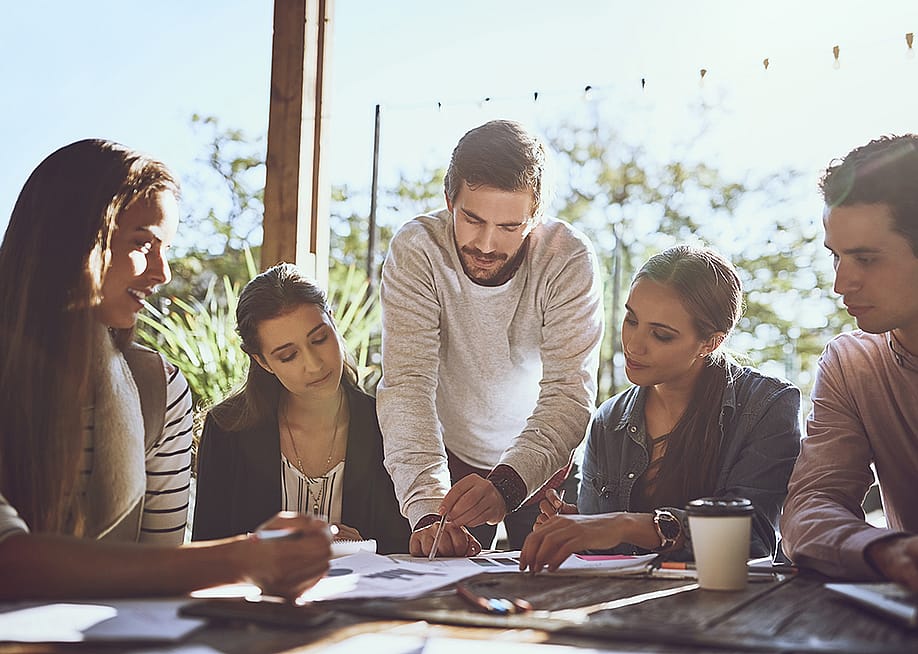 A business team brainstorming during a meeting. — PeopleImages // Shutterstock