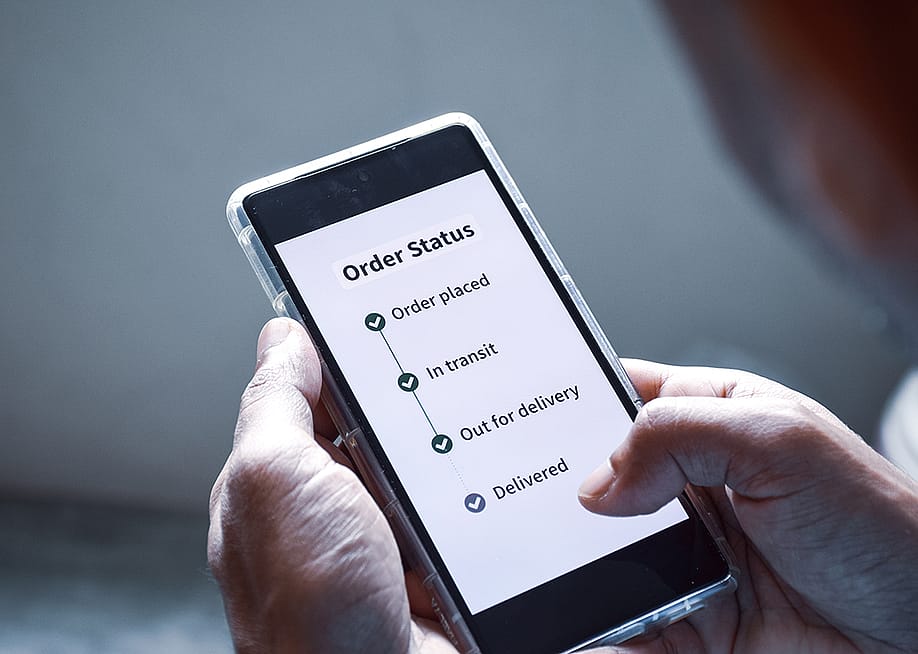 Person checking the order status of an item using smartphone. — Linaimages // Shutterstock
