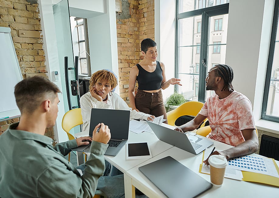 A diverse Gen Z business team in a meeting room. — LightField Studios // Shutterstock