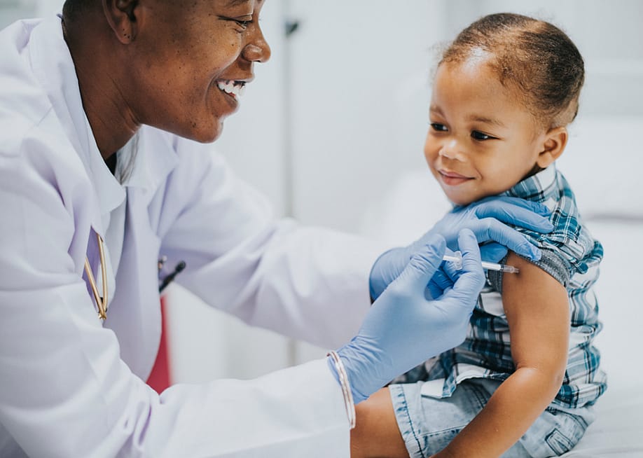 A pediatrician giving a toddler a vaccination. — Rawpixel.com // Shutterstock