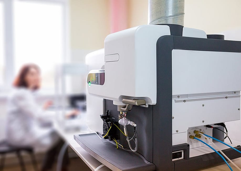 A focus on a microwave plasma atomic emission spectrometer (MPAES) a scientist is working with in a laboratory. — Sodel Vladyslav // Shutterstock