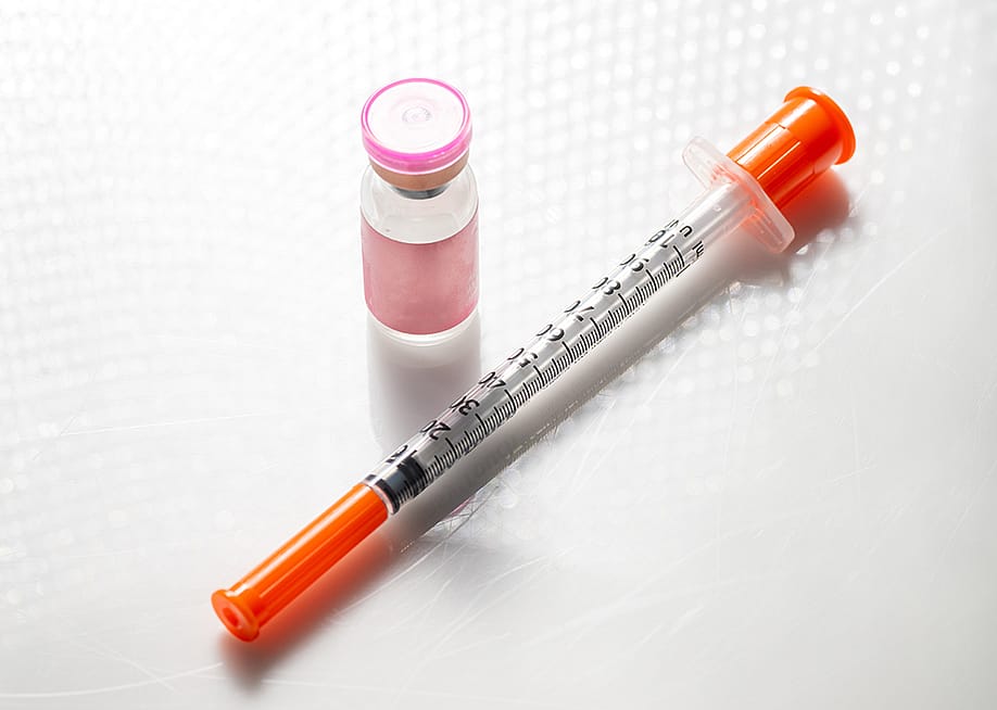 A vial with injectable compound and a syringe. — Anna Hoychuk // Shutterstock