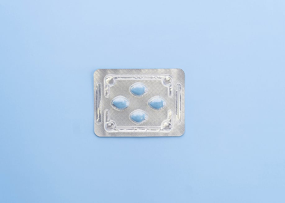 A blister package of Sildenafil, also known as Viagra, on a blue background. — Orawan Pattarawimonchai // Shutterstock
