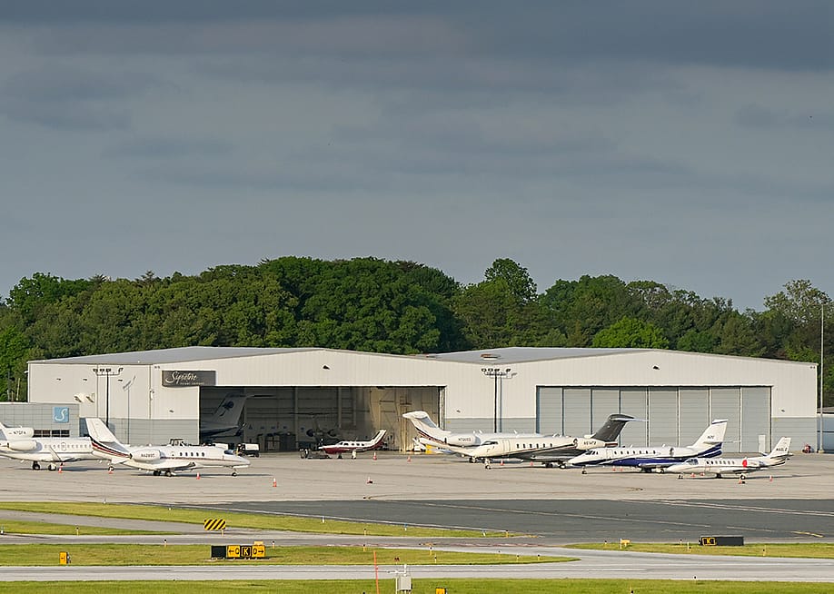 Private jets lined up outside at an airport terminal in Baltimore. — Ceri Breeze // Shutterstock