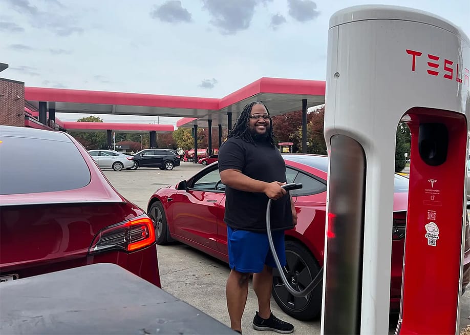 Phillip Stafford charges his car with a Tesla charger at his preferred gas station, Sheetz. — Benton Graham for Grist