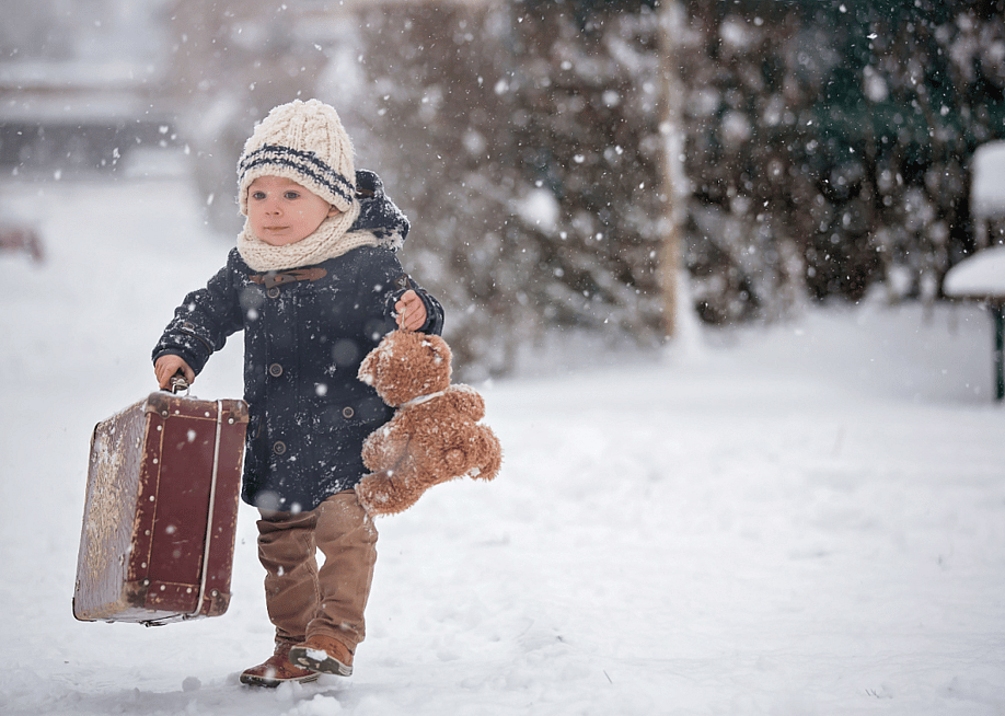 Baby playing with teddy bear in the snow. — Tomsickova Tatyana // Shutterstock