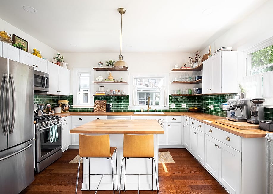 Interior of a modern kitchen with wooden and green layout motifs. — Joseph Hendrickson // Shutterstock
