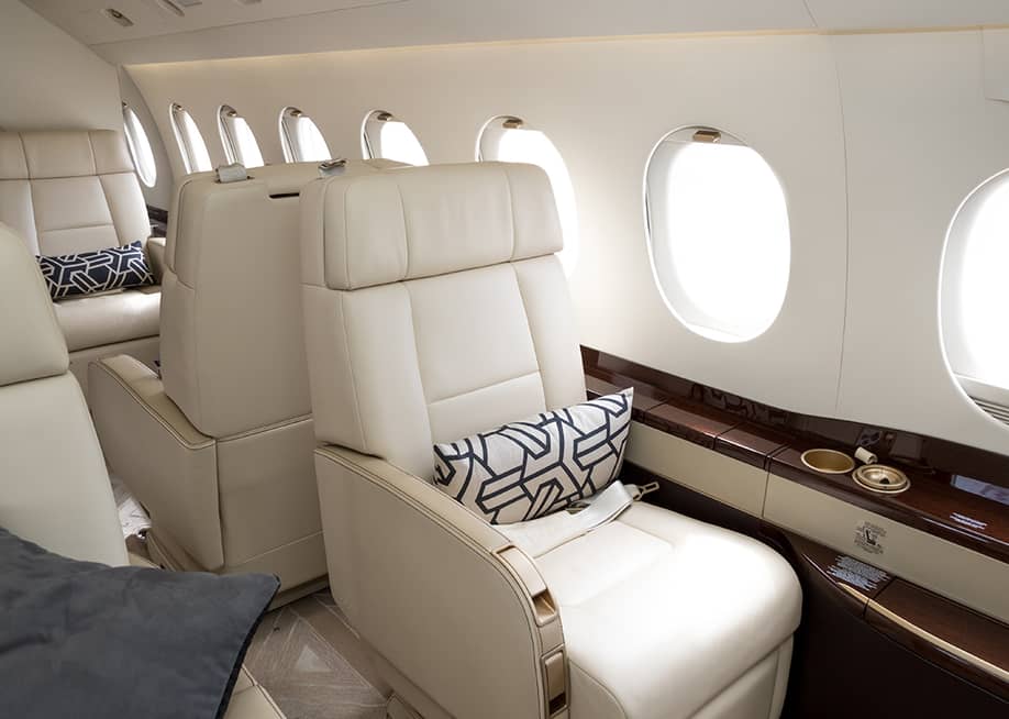 Cream-colored leather seats in a private business jet. — VanderWolf Images // Shutterstock