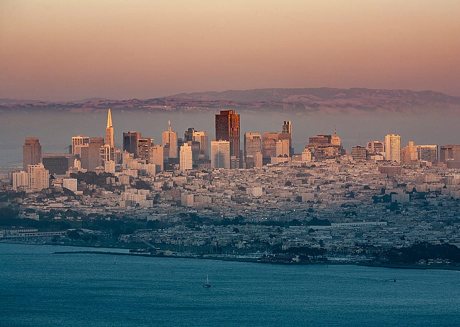 A foggy view of the San Francisco skyline during sunset. — travelview // Shutterstock