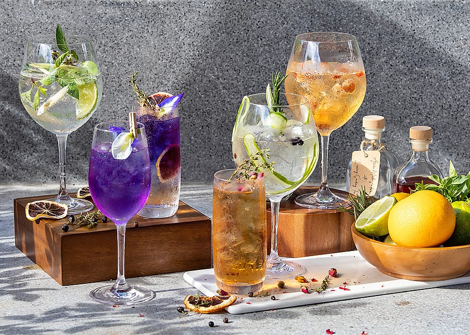 A display of assorted homemade herbal cocktails in wine glasses. — kanin sakulsillapakorn // Shutterstock