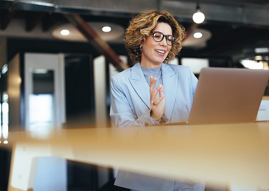 A businesswoman on a video call in an office. — Jacob Lund // Shutterstock