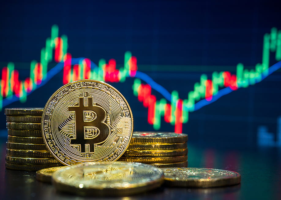 Bitcoin with a background of stock and finance chart graphics. — Summit Art Creations // Shutterstock