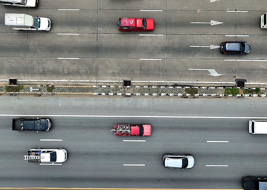 Aerial view of moving vehicles on a multi-lane highway. — Andromeda stock // Shutterstock