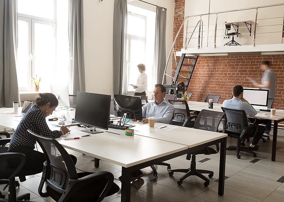 Members of a business team working in a modern office space. — fizkes // Shutterstock