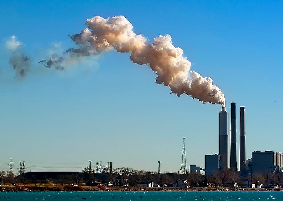 View of heavy smoke coming out of an industrial plant. — Dennis MacDonald // Shutterstock
