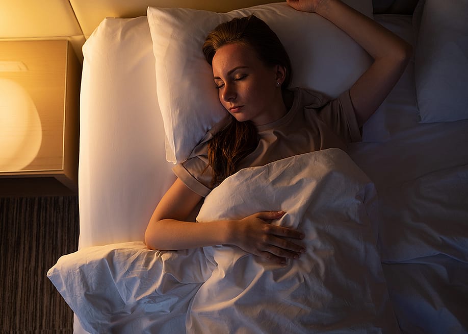 A young woman sleeping on her back. — Grustock // Shutterstock