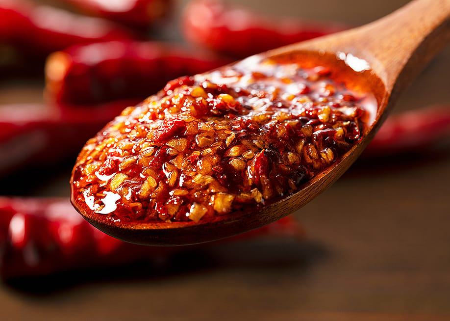 Chili oil scooped up with a wooden tablespoon. — masa44 // Shutterstock