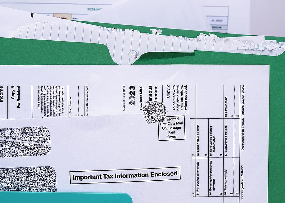 A document folder closed up on a US income tax Form 1099-MISC document. — Marianne Campolongo // Shutterstock