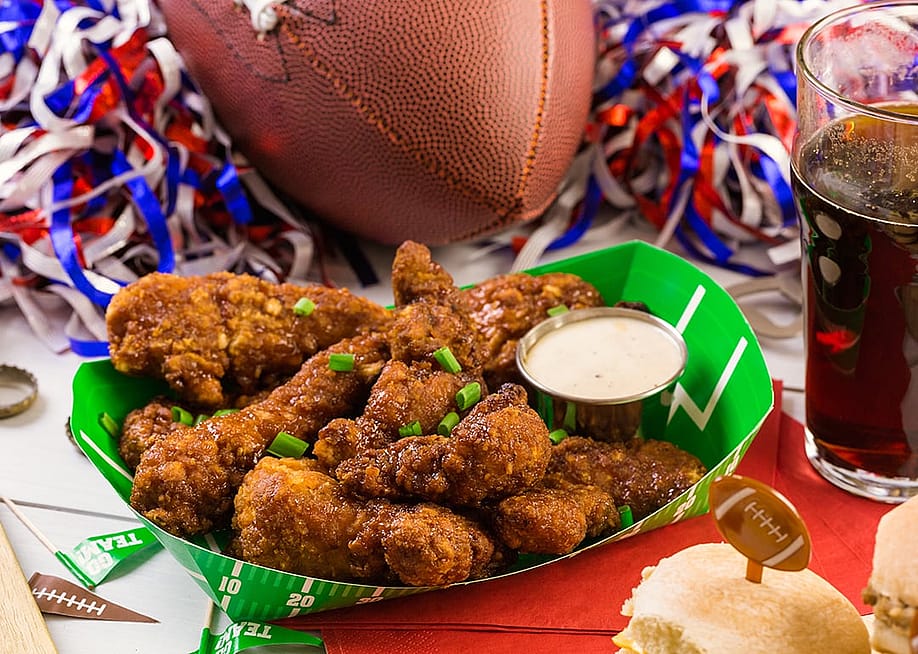 A plate of buffalo chicken wings for a football game day. — Arina P Habich // Shutterstock