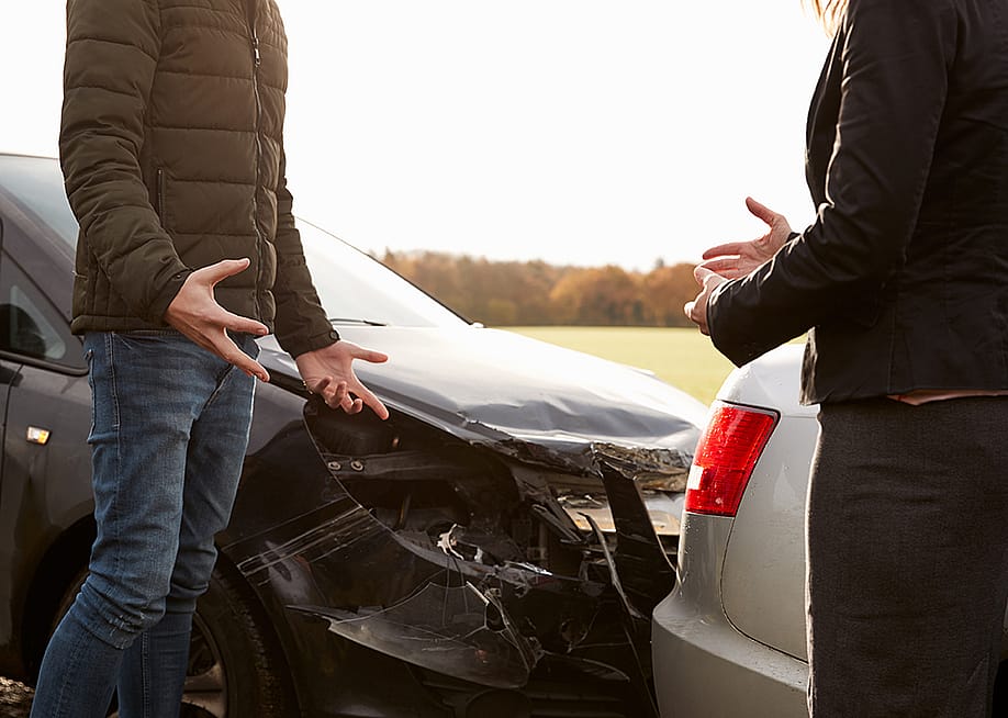 Two drivers arguing after a road accident. — Monkey Business Images // Shutterstock