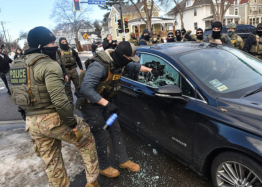 ICE officers breaking a car window to remove a woman from her vehicle on January 13, 2026 in Minneapolis, Minnesota. — Octavio JONES // AFP via Getty Images