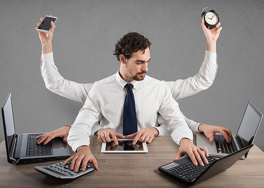 A businessman illustrated with multiple arms and hands as a concept of multitasking. — alphaspirit.it // Shutterstock