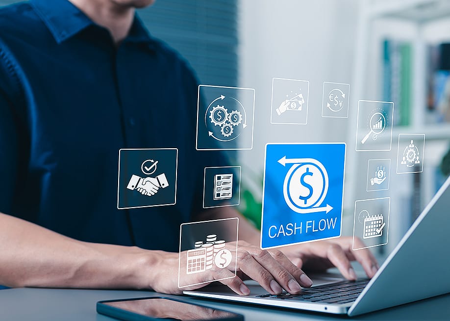 Businessman using laptop illustrated with cash flow application graphics. — SuPatMaN // Shutterstock