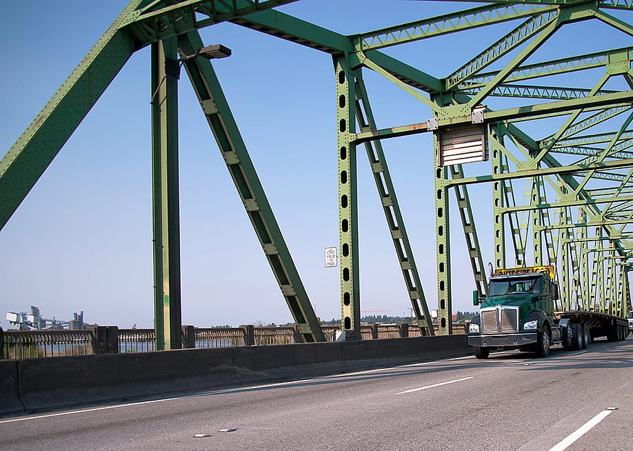 An empty transport semi truck going through a bridge. — Vitpho // Shutterstock