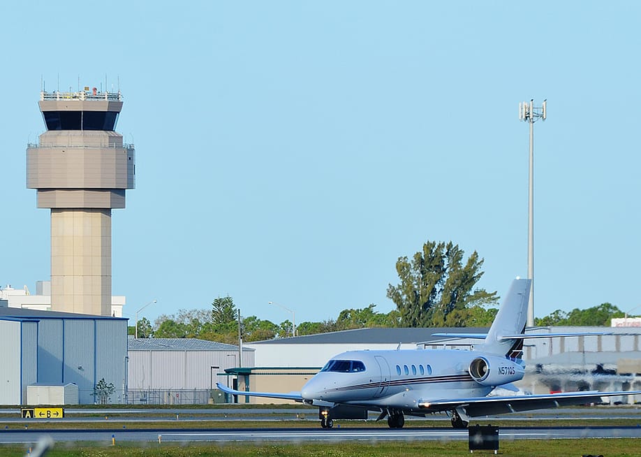 A private Charter Cessna Citation Latitude Jet on a runway in Sarasota-Bradenton International Airport. — Ja7 // Shutterstock