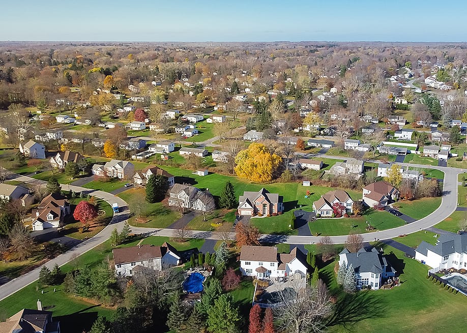 An aerial view of suburban residential homes in Rochester, New York. — Trong Nguyen // Shutterstock