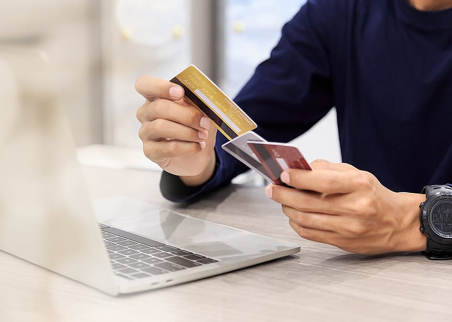 Man holding multiple credit cards. — A_stockphoto // Shutterstock