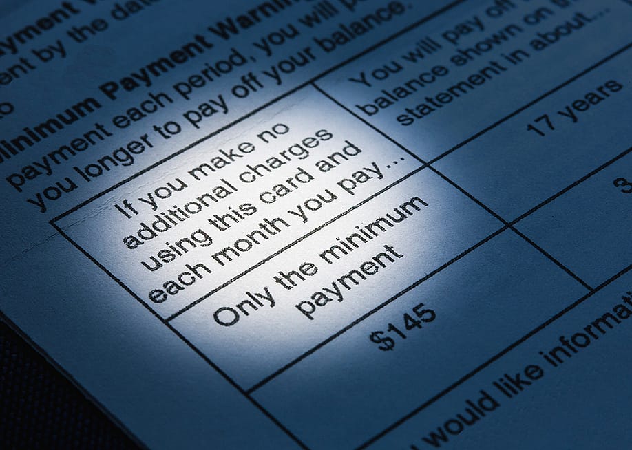 A close up view on the minimum payment terms in a credit card bill. — ImagineerInc // Shutterstock
