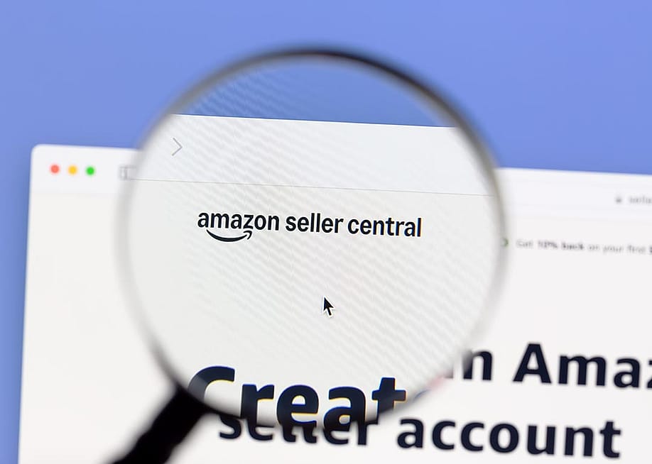 A magnifying glass over 'Amazon Seller Central' page. — IB Photography // Shutterstock