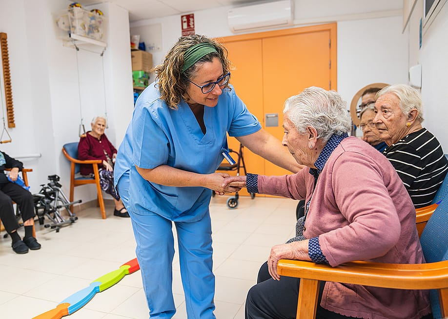 A nurse assisting one of the elderly residents of a nursing home. — koldo_studio // Shutterstock
