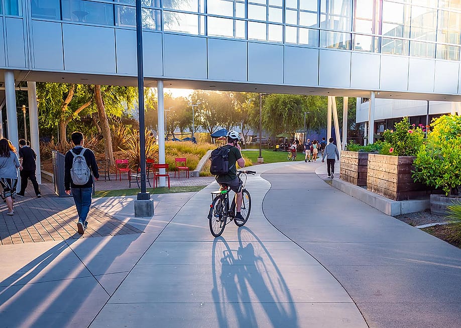 People walking and cycling around the Google headquarters. — arkanto // Shutterstock