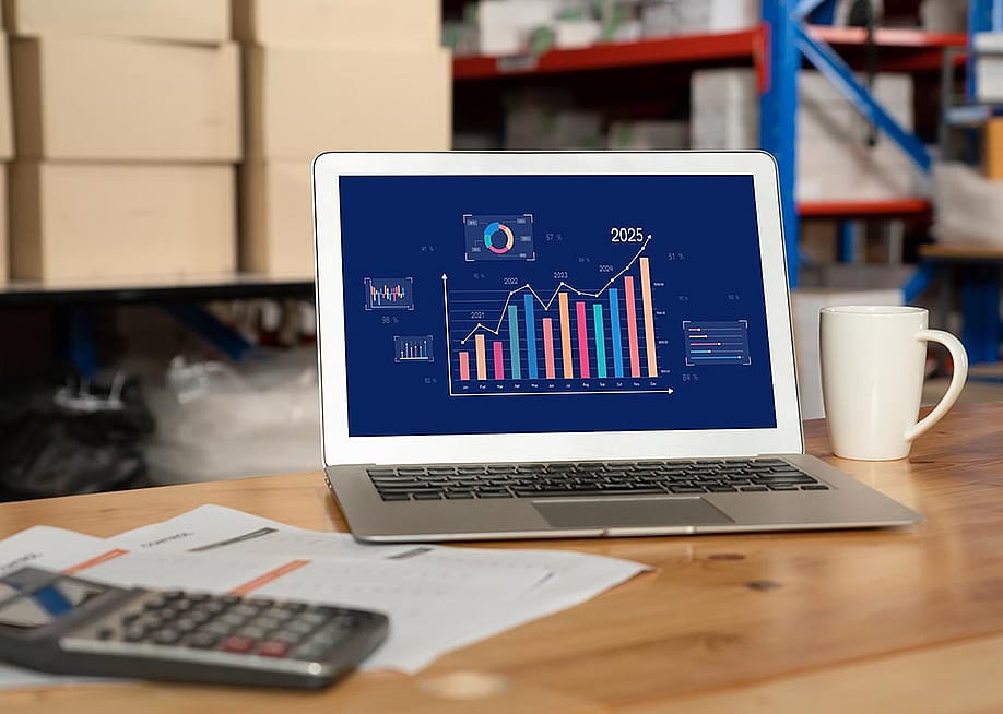 Data dashboard displayed on a laptop inside a warehouse. — Summit Art Creations // Shutterstock