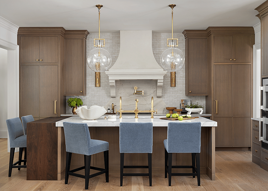 A kitchen with wooden cabinets, modern gold fixtures and light blue velvet chairs around a center island. — Designer: Mister + Mrs Sharp; Photo: Robert Peterson // Rustic White Photography