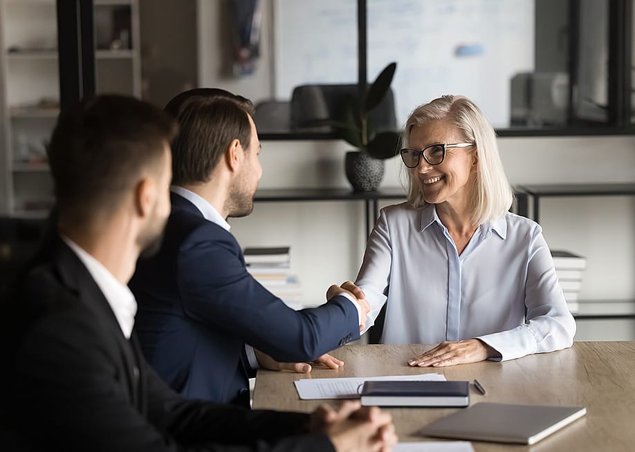 Business partners shaking hands during a meeting. — fizkes // Shutterstock