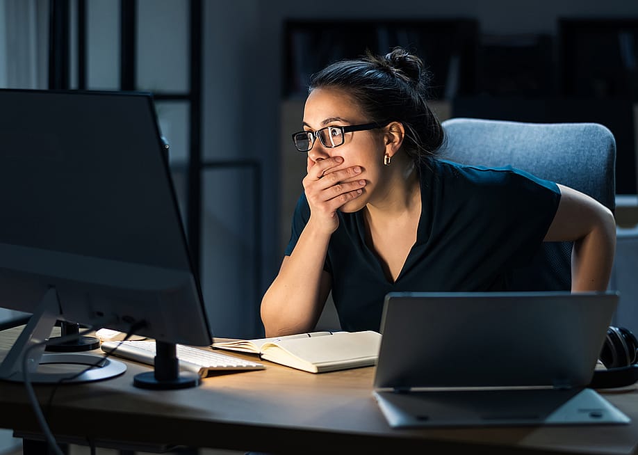 A female employee shocked in front of a computer seeing data hacked. — Andrey_Popov // Shutterstock