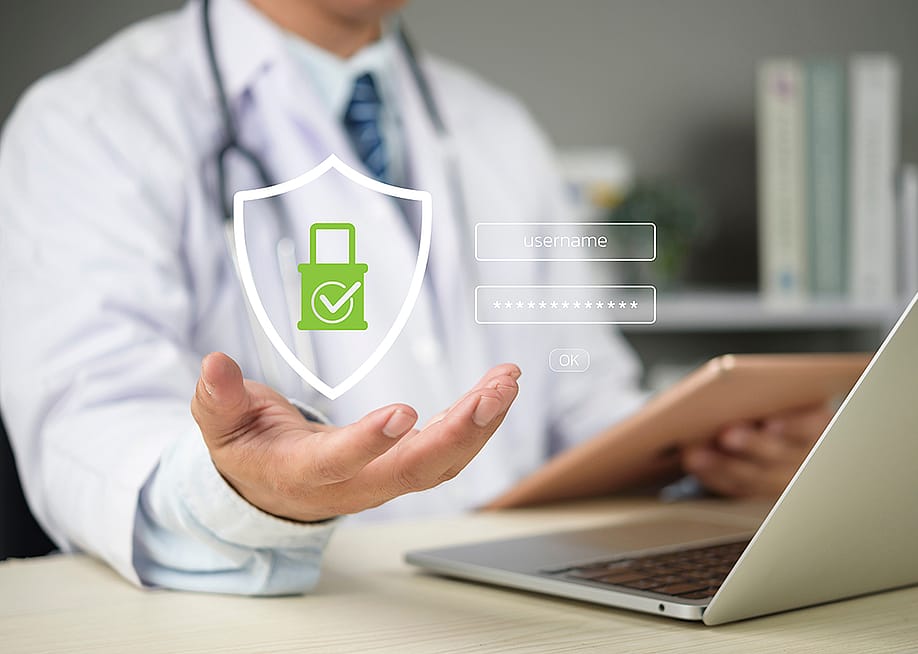 A doctor's hand holding up a graphic of medical data login as a concept of medical data security. — khunkornStudio // Shutterstock