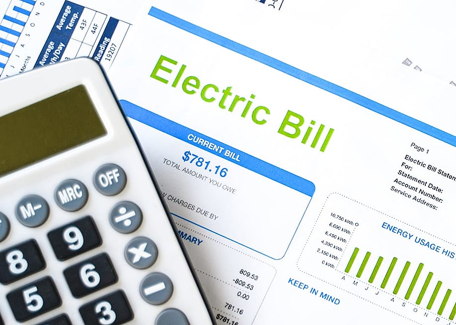 A calculator and an electric bill. — F01 PHOTO // Shutterstock