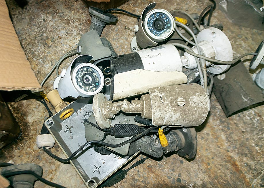 Assorted old and dusty surveillance cameras and electronic parts. — panumas nikhomkhai // Shutterstock