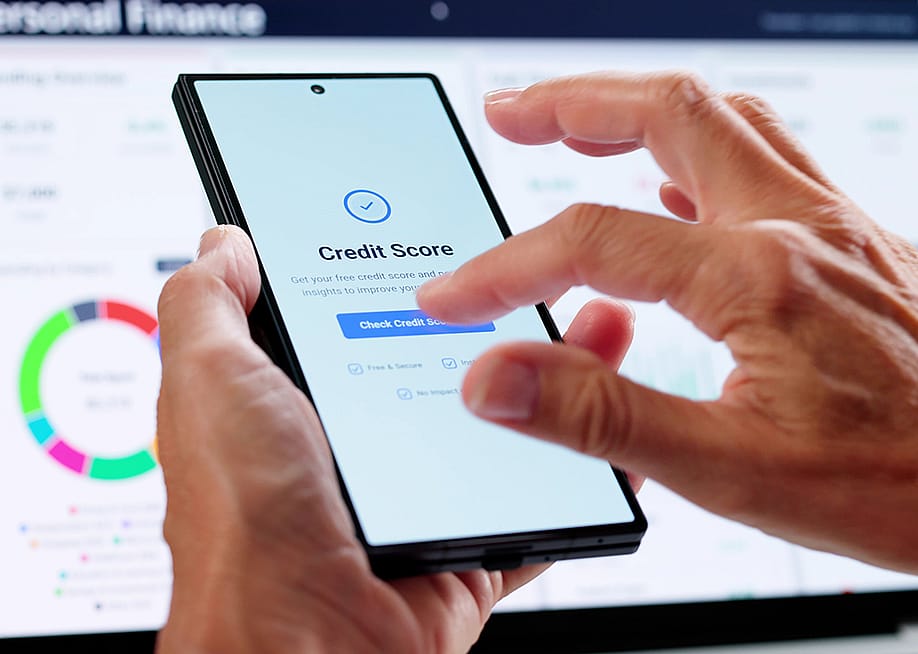 Person checking credit score online using smartphone. — Andrey_Popov // Shutterstock