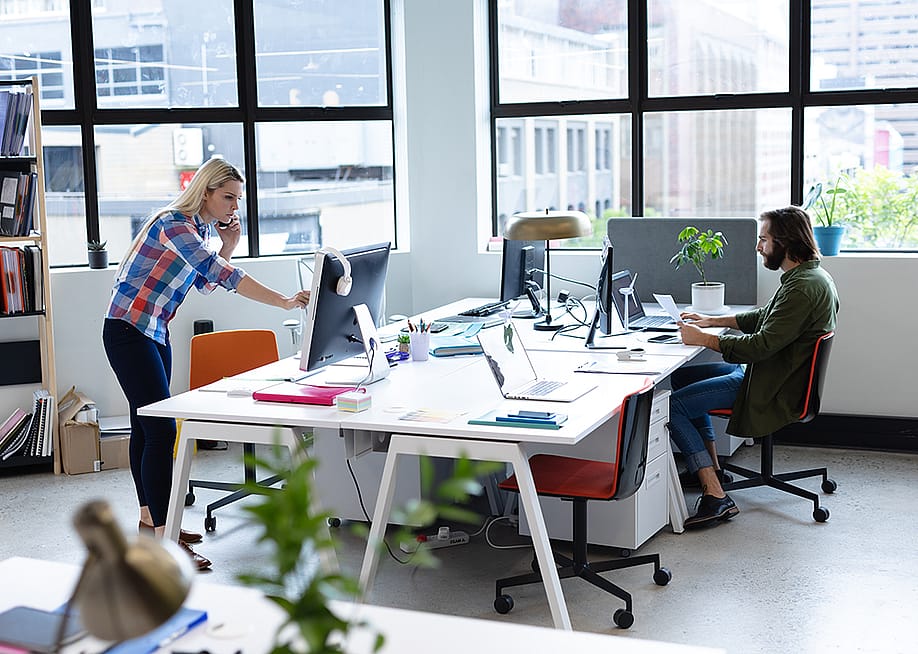 Two businesspeople working in a creative office. — wavebreakmedia // Shutterstock