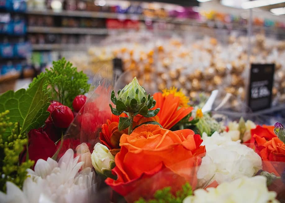 A close up on flowers for sale at the grocery store. — Tauva // Shutterstock