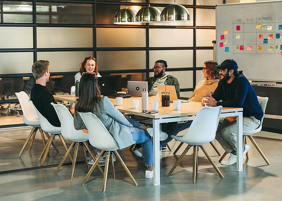 A business team brainstorming in a modern office. — Jacob Lund // Shutterstock